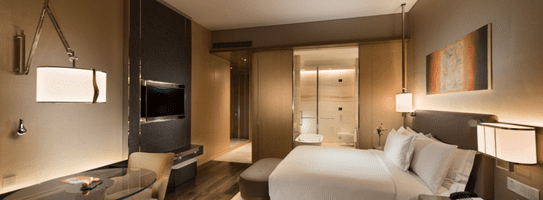 Spacious Premier Room bedroom setup ideal for a luxurious staycation